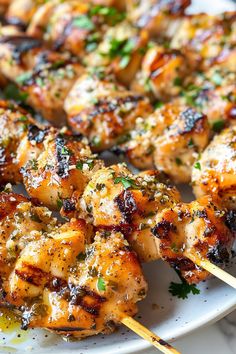 grilled chicken skewers on a white plate