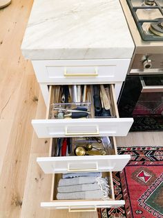 an open drawer in the middle of a kitchen