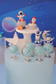 a cake with frosting and decorations on it, including snowman figurines