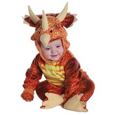 a baby in a dragon costume sitting on the ground with it's mouth open