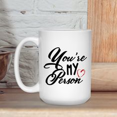 a white coffee mug with the words you're my person on it