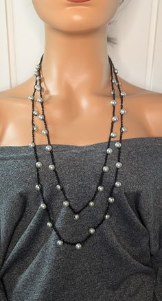 Add a touch of elegance to your outfit with this beautiful long double strand crochet necklace, adorned with shimmering glass pearl beads. Handcrafted with care, this unique piece is perfect for any occasion, whether it's a casual day out or a special event. The delicate crochet work combined with the lustrous pearls creates a timeless look that will never go out of style. Lightweight and comfortable to wear, this necklace makes an excellent gift for yourself or a loved one. Enhance your jewelry collection with this stunning, versatile accessory. This beautiful handmade double strand crochet beaded Necklace is made using Czech satin luster glass pearl beads and nylon wax cord, this necklace Measures 34 inches and is a slip-on necklace no clasp. Simple yet elegant this design makes it easy Elegant Double Strand Beaded Necklaces, Elegant Multi-strand Glass Beaded Necklaces, Formal Black Multi-strand Beaded Necklaces, Formal Multi-strand Black Beaded Necklaces, Black Multi-strand Beaded Necklace For Evening, Handmade Multi-strand Black Necklace, Crochet Beaded Necklace, Pearl Beads, Handmade Crochet