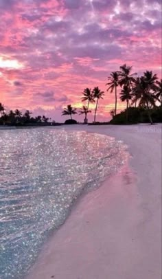 an image of the beach at sunset with palm trees and clouds in the background, taken on instagram