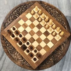 a wooden chess board with pieces on it