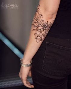 a woman with a tattoo on her arm