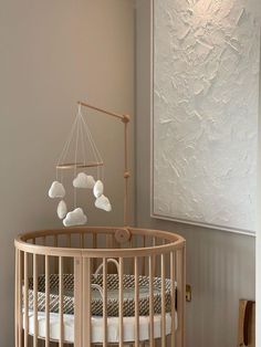 a baby crib in a room with white walls and wood trimmings on the wall