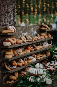 an assortment of doughnuts on display at a wedding