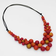 Adorn yourself with the elegance and artistry of the Spice Pamela Berries Necklace. This statement necklace features stunning orange and yellow beads, expertly wrapped and closely knotted for a luxurious and exclusive look. A popular addition to any wardrobe, this lightweight and adjustable necklace is sure to make a statement and elevate any outfit. Adjustable length: 18'-28" Care Instructions: Remove jewelry when applying perfumes, creams, washing hands etc. Do not store in direct sunlight. to restore color and shine apply a drop of oil with a soft cloth Wooden Bead Necklace, Colored Necklace, Wooden Bead Necklaces, Washing Hands, Double Strand Necklace, Necklace Red, Necklace Statement, Colourful Necklace, Orange And Yellow