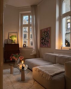 a living room filled with furniture and windows