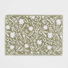 a green and white placemat with an intricate design on it, against a white background