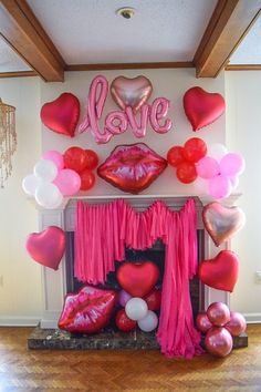 valentine's day decoration with balloons and heart - shaped lips on the fireplace mantel