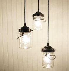 three mason jar lights hanging from a ceiling