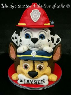 a cake with a dog and fireman hat on it