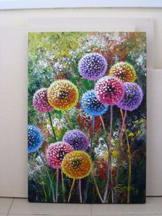 a painting of colorful flowers on a white wall