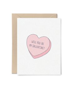 a pink heart shaped card with the words will you be my valentine? on it