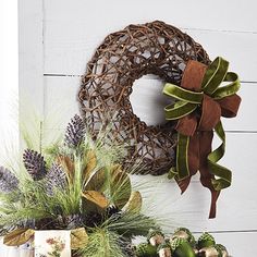 two wreaths are on the wall next to other decorations