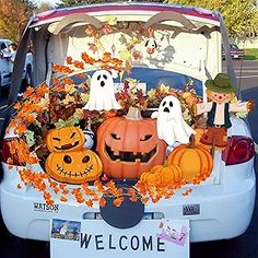 a car decorated for halloween with pumpkins and jack - o'- lanterns