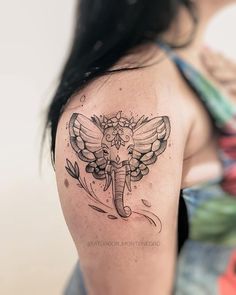 a woman with a tattoo on her arm and an elephant in the middle of it