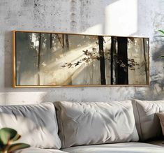 a painting hanging on the wall above a couch in a room with white walls and pillows