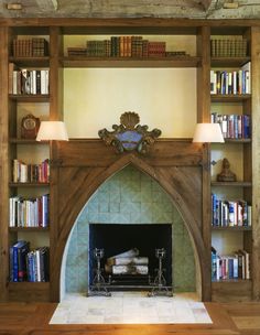 the fireplace is surrounded by bookshelves and shelves