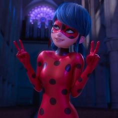 a woman in a red and black polka dot dress is making the peace sign with her hands