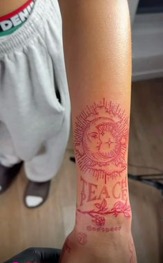 a person with a tattoo on their arm that reads peace and has the sun above it