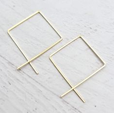 Minimalist style Square 14 Karat Gold Filled Open Hoop Threader Earrings * Made with 20 guage 14 karat gold filled square wire * Measure 1.5 inch in length * Also available in sterling silver here * Polished to a high shine * Handmade to Order SHIPPED GIFT READY IN BEAUTIFUL BOX AND A POLISHING CLOTH * Choice of earring packaging with fun quotes! (Picture 3) These are thoughtfully handmade in my mountain studio at time of order, making each one unique. Nothing in my shop is mass produced. Every Minimalist Square Gold Hoop Earrings, Earring Packaging, Silver Wire Earrings, Wire Hoop Earrings, Open Hoop Earrings, Earring Cards, Fun Quotes, You're Awesome, Threader Earrings