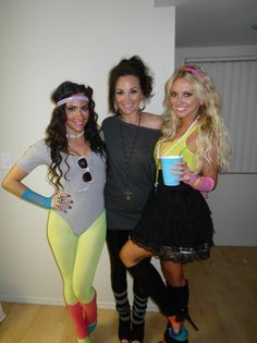 three women dressed up in costumes posing for the camera with one holding a coffee cup