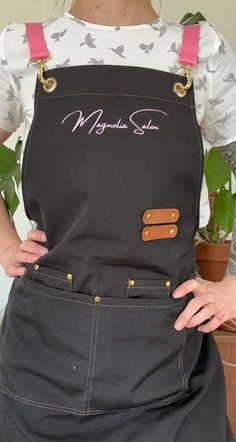 a woman wearing an apron with the name morgan's cafe on it and holding her hands behind her back