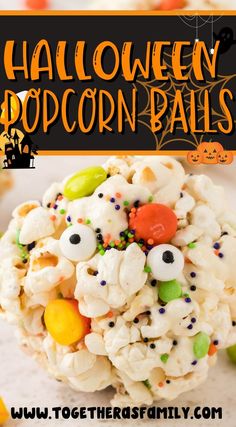 halloween popcorn balls with candy eyes and sprinkles on top, in front of a