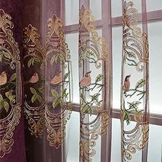 the curtains are hanging in front of the window with birds on them and green leaves