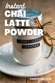 a jar filled with chai latte powder on top of a white plate