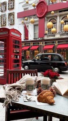 a table that has some food on it and a phone booth in the back ground