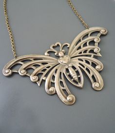 "Vintage Jewelry - Art Nouveau Necklace - Butterfly Necklace - Statement Necklace - Brass Necklace - Chloe's Vintage handmade jewelry This is such a stunning statement necklace! A large vintage brass butterfly hangs from a pretty brass ladder chain. So very bold and feminine. Chloe says, \"Wear it and feel fabulous!\" This pendant is 4\" wide and 2 1/4\" tall. You can choose the necklace length you would like at checkout. Thanks for visiting Chloe's" Metal Necklace For Gift, Decorative Metal Necklace As Gift, Decorative Metal Necklace For Gift, Unique Nickel Free Necklace For Wedding, Handmade Bronze Necklaces For Wedding, Artistic Silver Jewelry With Decorative Details, Artistic Silver Decorative Jewelry, Art Nouveau Necklaces, Bijoux Art Nouveau