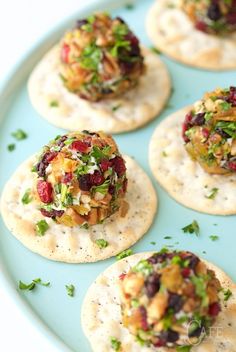 small crackers with various toppings on a blue plate