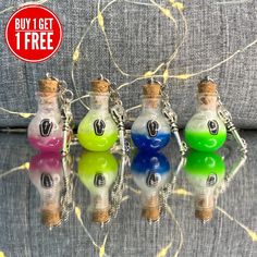 four small bottles with numbers on them are sitting in front of a gray couch and there is a price tag for one bottle