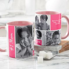 two pink coffee mugs sitting on top of a table next to marshmallows