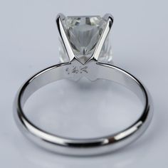 a white gold ring with a princess cut diamond