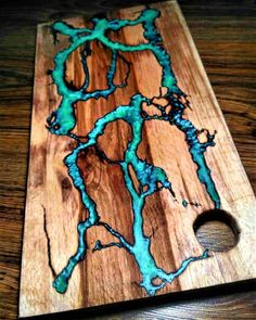 a wooden cutting board with blue paint on it