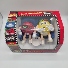 two toy figurines sitting in a box