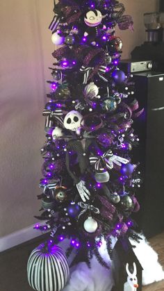 a purple and black christmas tree decorated with skulls