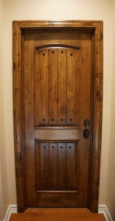 a wooden door in the corner of a room