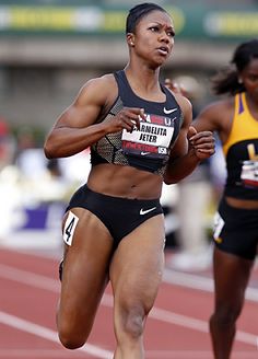 two female athletes running on a track