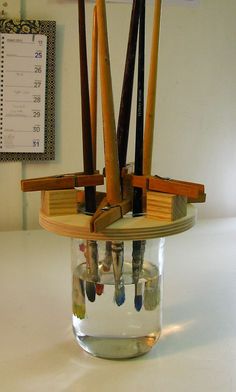 a glass jar filled with lots of wooden sticks