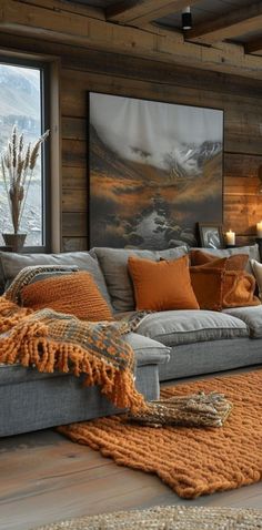 a living room filled with lots of furniture next to a large painting on the wall