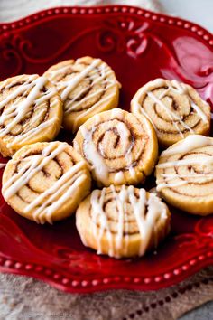 cinnamon rolls with icing on a red plate