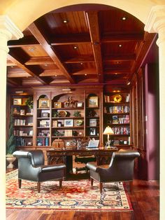 a living room filled with lots of furniture and bookshelves