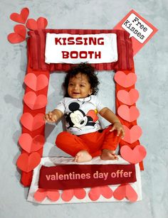 a valentine's day photo frame made to look like a kissing booth for a baby