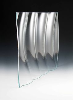 an abstract glass sculpture with wavy lines on it