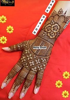 henna on the hand with yellow flowers and words written in white letters that spell out love